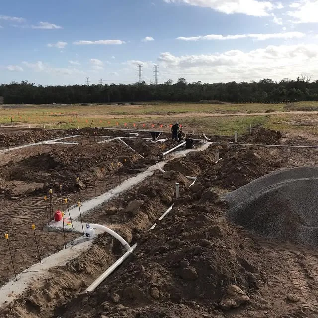 New drainage pipes laid in open trenches on a fresh estate block